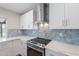 Updated kitchen showcases stainless steel appliances and stylish tile backsplash at 2502 S Mollera Cir, Mesa, AZ 85210