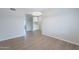 Bright space leads into a room with white cabinets in the background and new wood look floors at 2502 S Mollera Cir, Mesa, AZ 85210