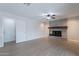Inviting living room features a brick fireplace and wood-look floors at 2502 S Mollera Cir, Mesa, AZ 85210