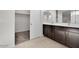 Bathroom featuring a large closet and a double sink vanity at 2506 N Pony Ln, Casa Grande, AZ 85122