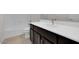 Modern bathroom featuring a white countertop, dark cabinets, and a bathtub with white tiling at 2506 N Pony Ln, Casa Grande, AZ 85122