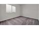 This bedroom features neutral walls, carpet flooring, a window, and electrical outlets at 2506 N Pony Ln, Casa Grande, AZ 85122