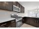 Kitchen with stainless steel oven and microwave and plenty of dark wood cabinets at 2506 N Pony Ln, Casa Grande, AZ 85122