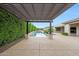 Backyard showcasing a swimming pool with mature privacy landscaping, viewed from under a pergola at 2735 E King Bird Dr, Gilbert, AZ 85297