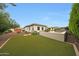 Expansive backyard with lush green lawn, desert landscaping, and a tranquil ambiance at 2735 E King Bird Dr, Gilbert, AZ 85297