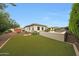 Expansive backyard with lush green lawn, desert landscaping, and a tranquil ambiance at 2735 E King Bird Dr, Gilbert, AZ 85297