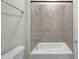 Tiled shower-tub combo with chrome fixtures in a bright, modern bathroom at 2735 E King Bird Dr, Gilbert, AZ 85297
