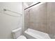 Clean bathroom with a shower-tub combo featuring sleek tile and a white toilet at 2735 E King Bird Dr, Gilbert, AZ 85297