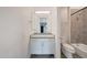 Well-lit bathroom featuring a granite countertop vanity, white cabinets, and tiled floor at 2735 E King Bird Dr, Gilbert, AZ 85297