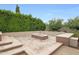 A cozy outdoor fire pit area surrounded by lush greenery offers a relaxing space for gatherings at 2735 E King Bird Dr, Gilbert, AZ 85297