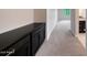 Long carpeted hallway with a built in cabinet leading to the kitchen area at 2735 E King Bird Dr, Gilbert, AZ 85297