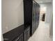 Hallway featuring dark cabinets and drawers leading to a room with storage shelves at 2735 E King Bird Dr, Gilbert, AZ 85297