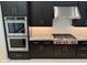 Gourmet kitchen featuring stainless steel appliances, rich dark cabinetry, and ample counter space at 2735 E King Bird Dr, Gilbert, AZ 85297