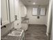 Well-appointed laundry room featuring modern cabinets, granite counters, and TESLA powerwall system at 2735 E King Bird Dr, Gilbert, AZ 85297