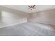 Open and bright living room featuring modern ceiling fan and plush carpeting at 2735 E King Bird Dr, Gilbert, AZ 85297