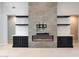 Living room with built-in shelves, modern fireplace, and light wood floors at 2735 E King Bird Dr, Gilbert, AZ 85297