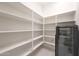 Walk-in pantry with white shelves offering ample storage space and a beverage fridge at 2735 E King Bird Dr, Gilbert, AZ 85297