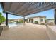 This backyard features a covered patio, an outdoor kitchen, and a swimming pool at 2735 E King Bird Dr, Gilbert, AZ 85297