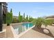Swimming pool with professional landscaping and a small water feature, creating a serene backyard oasis at 2735 E King Bird Dr, Gilbert, AZ 85297