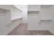 Spacious walk-in closet with built in shelving and rack system and plush carpeting at 2735 E King Bird Dr, Gilbert, AZ 85297