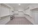 Spacious walk-in closet with built in shelving and rack system and plush carpeting at 2735 E King Bird Dr, Gilbert, AZ 85297