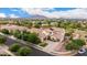 Impressive aerial view of a luxury home with a manicured lawn, multiple garages, and a serene neighborhood setting at 2851 E Alexander Ct, Gilbert, AZ 85298