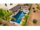 Overhead shot of a private backyard oasis with a modern pool, spa, and patio, surrounded by mature landscaping at 2851 E Alexander Ct, Gilbert, AZ 85298