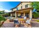 Expansive backyard with a built-in fire pit, outdoor seating area, and a covered patio for relaxation and entertaining at 2851 E Alexander Ct, Gilbert, AZ 85298