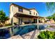 Beautiful backyard view of the pool, pergola, covered patio, and lush lawn creates an outdoor oasis at 2851 E Alexander Ct, Gilbert, AZ 85298