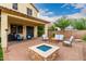 Inviting backyard featuring a paver patio with a fire pit and comfortable seating, perfect for outdoor entertaining at 2851 E Alexander Ct, Gilbert, AZ 85298