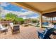 Inviting backyard featuring a covered patio, fire pit, and refreshing pool with spa, perfect for outdoor relaxation at 2851 E Alexander Ct, Gilbert, AZ 85298