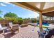 Luxurious outdoor living area with a covered patio, a fire pit, and a pool with a spa, creating the perfect retreat at 2851 E Alexander Ct, Gilbert, AZ 85298
