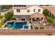 Aerial view of a backyard featuring a pool, spa, covered patio, fire pit, and seating area at 2851 E Alexander Ct, Gilbert, AZ 85298