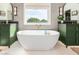 Bright and open bathroom with modern tub, cabinetry and double sinks at 2851 E Alexander Ct, Gilbert, AZ 85298