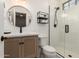 Modern bathroom features a glass enclosed shower, wood cabinetry, and elegant fixtures and accents at 2851 E Alexander Ct, Gilbert, AZ 85298