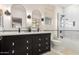 Elegant bathroom boasts a dual sink vanity, modern fixtures, and a luxurious tiled shower and tub combination at 2851 E Alexander Ct, Gilbert, AZ 85298