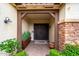 Inviting entryway with a decorative front door, manicured landscaping, and stylish accents at 2851 E Alexander Ct, Gilbert, AZ 85298