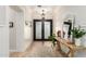 Bright foyer with decorative lighting, wood floors, and a view of the ornate front door at 2851 E Alexander Ct, Gilbert, AZ 85298