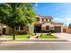 Charming two-story home with a well-maintained front yard, stone accents, and a spacious driveway at 2851 E Alexander Ct, Gilbert, AZ 85298