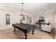 Large game room with pool table, cue rack, and relaxing lounge area at 2851 E Alexander Ct, Gilbert, AZ 85298