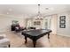 Spacious game room featuring a pool table, piano and comfortable seating area at 2851 E Alexander Ct, Gilbert, AZ 85298