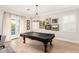 Bright game room featuring a pool table, light hardwood floors and backyard access at 2851 E Alexander Ct, Gilbert, AZ 85298