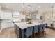 Bright kitchen featuring a large island with barstool seating, modern pendant lighting, and stainless steel appliances at 2851 E Alexander Ct, Gilbert, AZ 85298