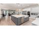 Open kitchen with a large gray island, white cabinets, and stainless steel appliances adjacent to the living space at 2851 E Alexander Ct, Gilbert, AZ 85298
