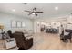 Open-concept living space with a view into the kitchen, featuring comfortable seating, a ceiling fan, and stylish decor at 2851 E Alexander Ct, Gilbert, AZ 85298