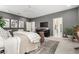 Spacious primary bedroom with elegant decor, plush carpet, and a cozy seating area at 2851 E Alexander Ct, Gilbert, AZ 85298