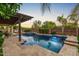 Backyard pool with lush landscaping and a covered patio area for outdoor entertaining at 2851 E Alexander Ct, Gilbert, AZ 85298