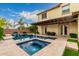 Stunning backyard featuring a sparkling pool with a spa, lush landscaping, and a covered patio at 2851 E Alexander Ct, Gilbert, AZ 85298
