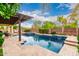 Relaxing backyard showcases a shimmering pool, spa, and shaded patio, perfect for outdoor living and entertaining at 2851 E Alexander Ct, Gilbert, AZ 85298