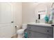 Stylish powder room with modern vanity and a decorative round mirror at 2851 E Alexander Ct, Gilbert, AZ 85298